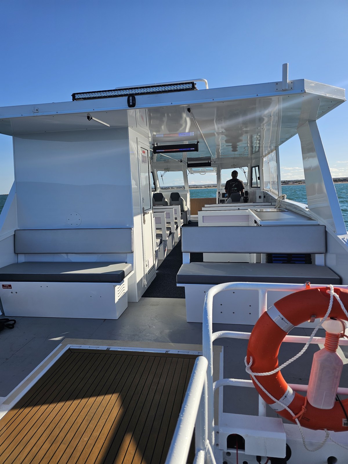 Shaded cabin and open deck on board the View Ningaloo power catamaran